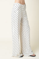 White pants with black polka dots on a white background