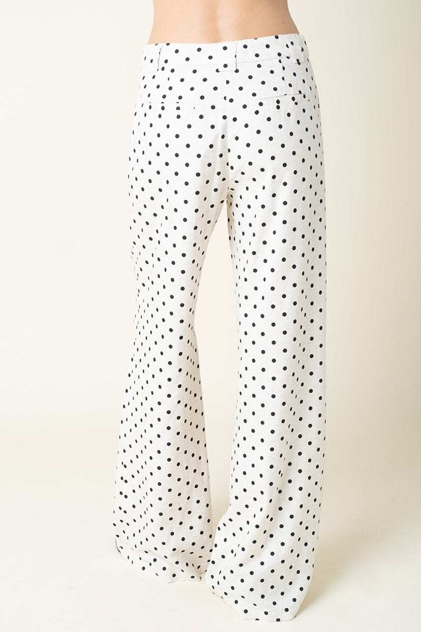 Polka dot pants on a plain background