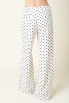 Polka dot pants on a plain background