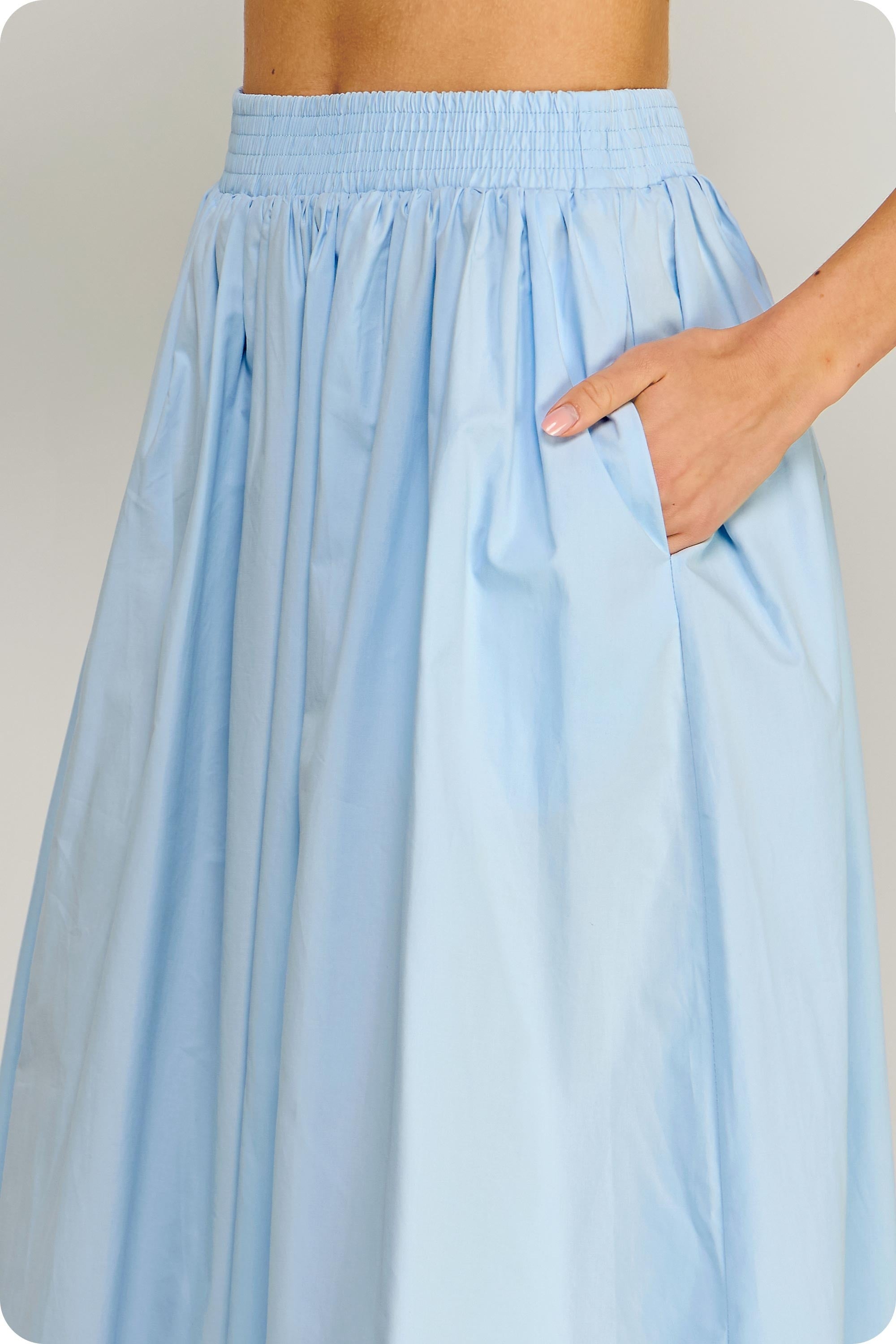 Light blue skirt worn by a person on a plain background