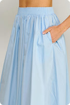Light blue skirt worn by a person on a plain background