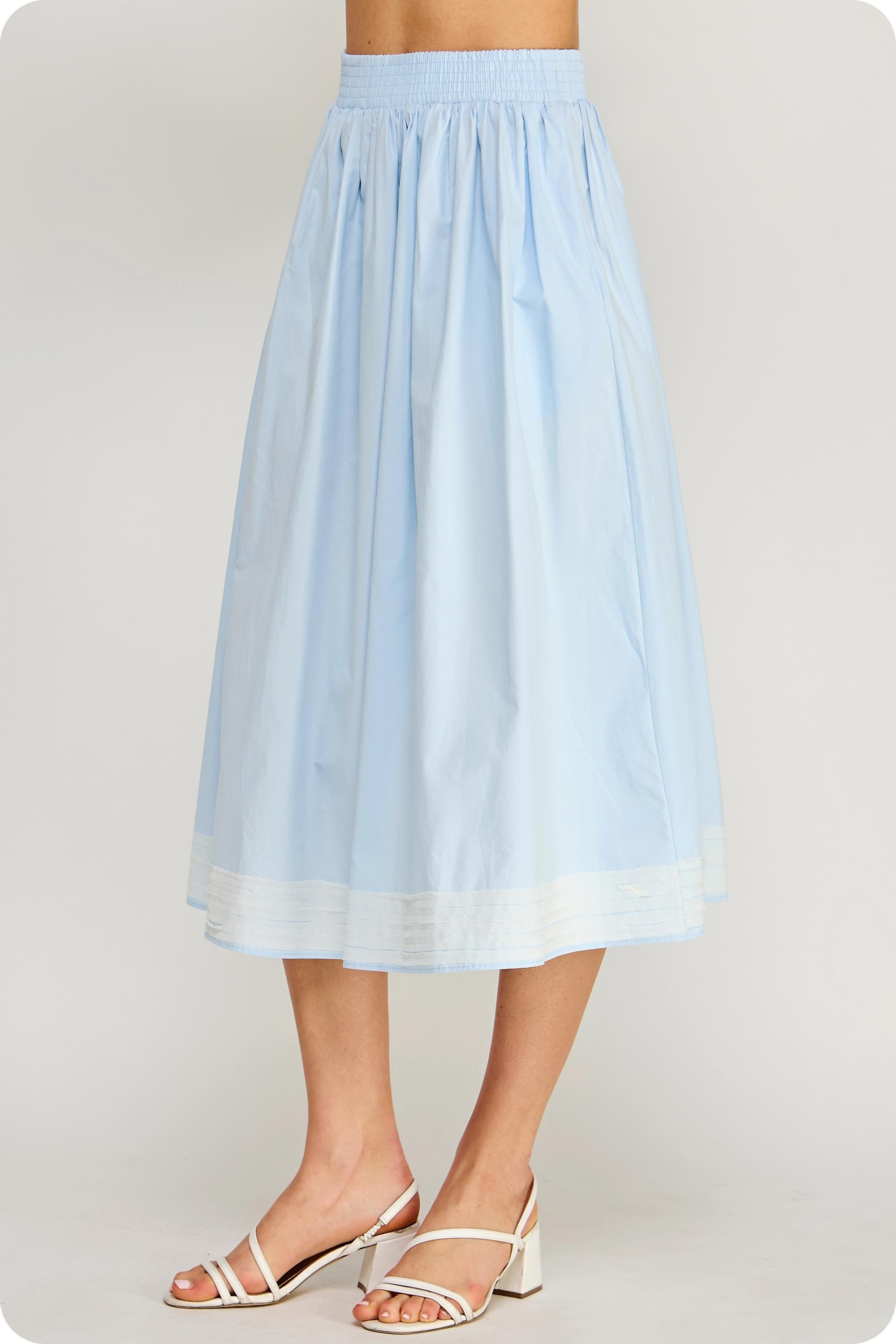 Light blue skirt worn by a person on a plain background