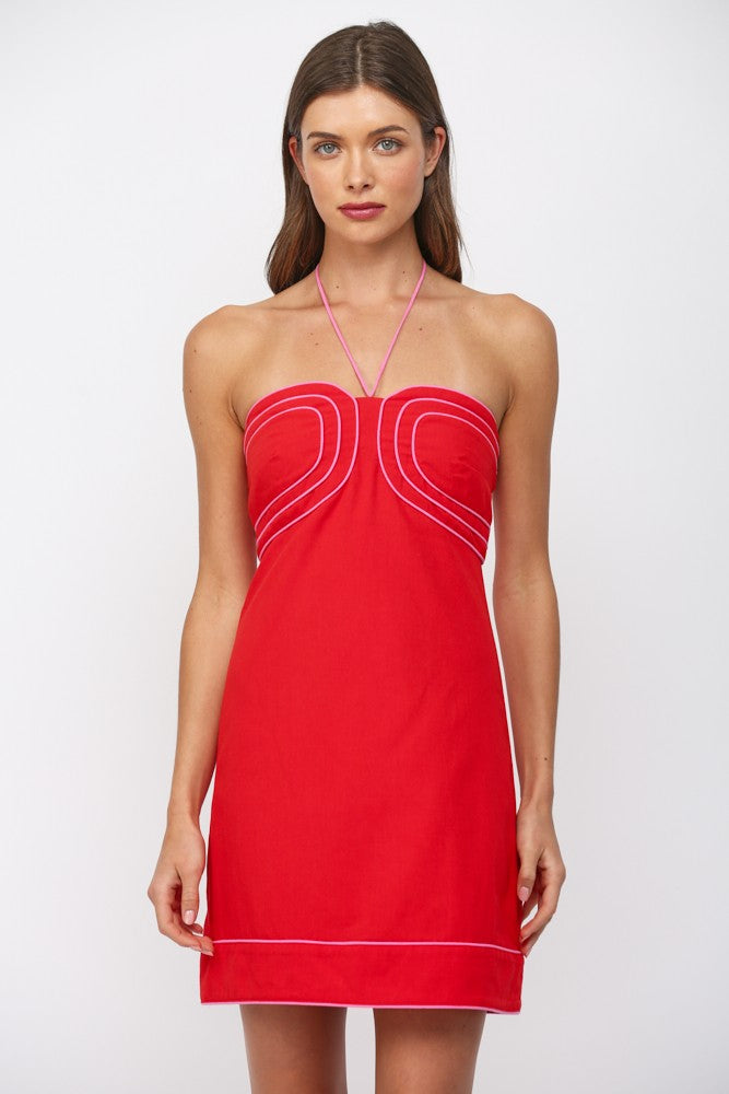 Red dress with white trim worn by a model on a white background