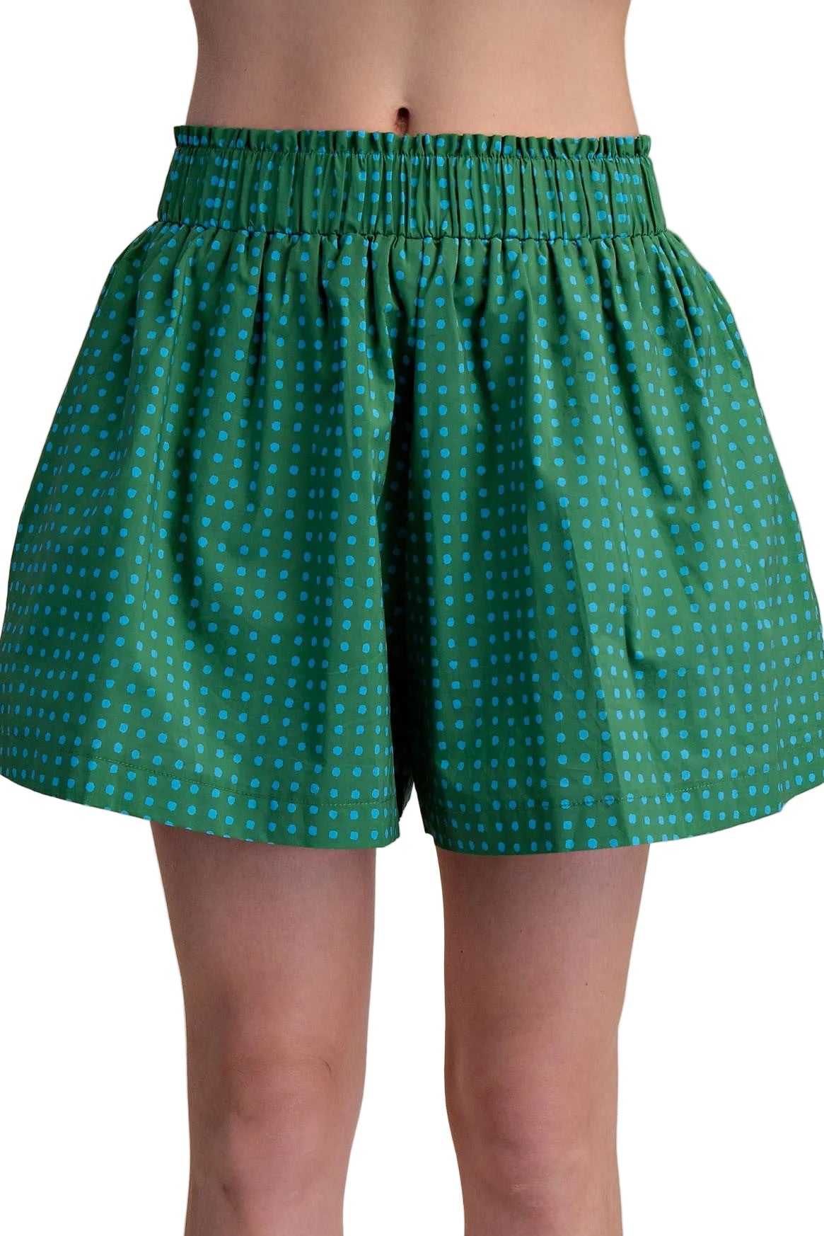 Green patterned shorts worn by a person on a beige background