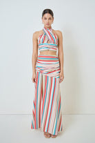 Woman wearing a colorful striped outfit on a white background