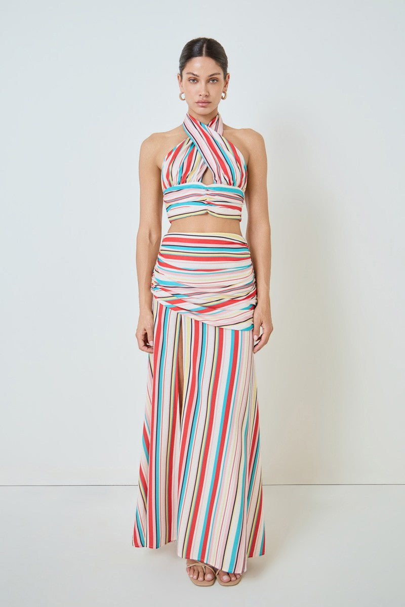 Woman wearing a colorful striped outfit on a white background