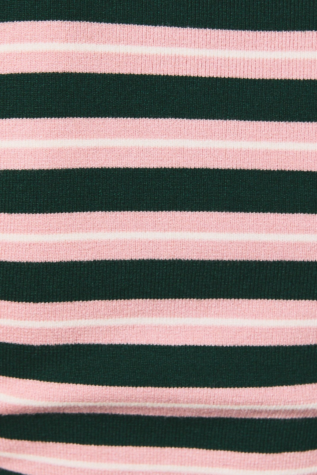 A close-up of a striped knit fabric with alternating dark green and light pink horizontal stripes.