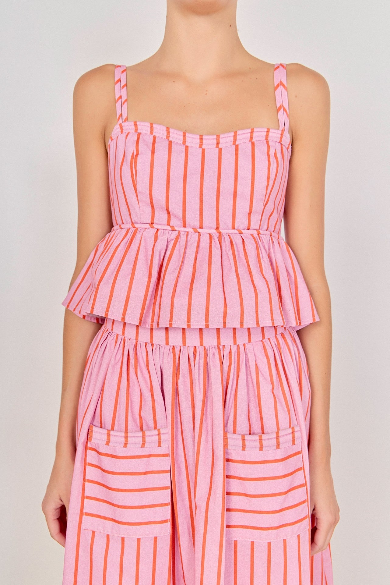 Pink and orange striped dress on a plain background