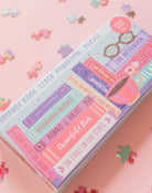 Puzzle box with colorful design on a pink background with puzzle pieces.