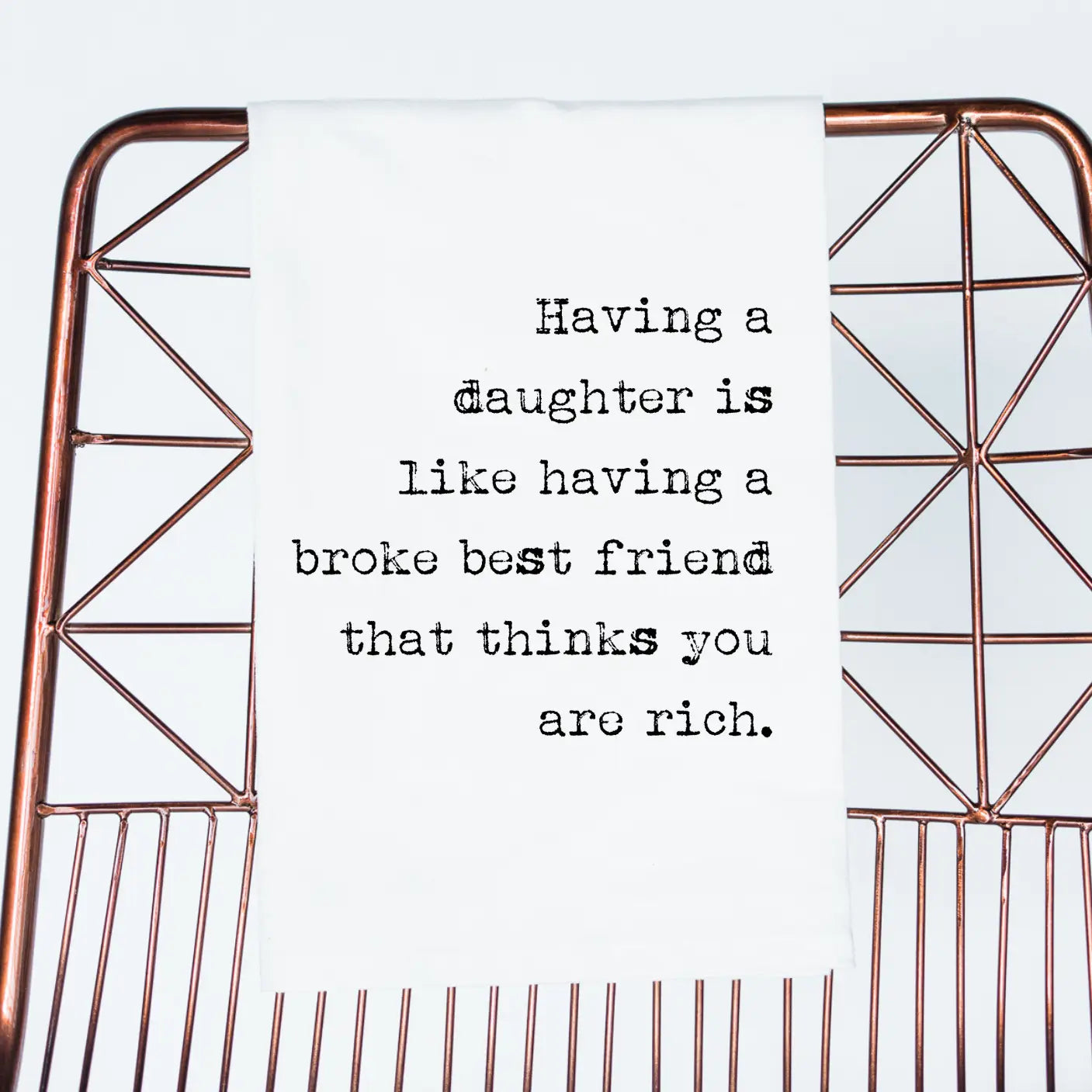 Decorative metal shelf with geometric design on a white background, featuring a humorous quote.