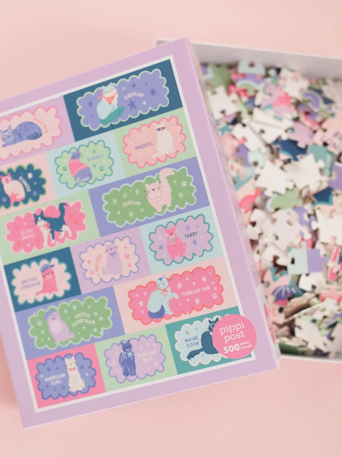 Puzzle box and a partially completed puzzle on a pink background