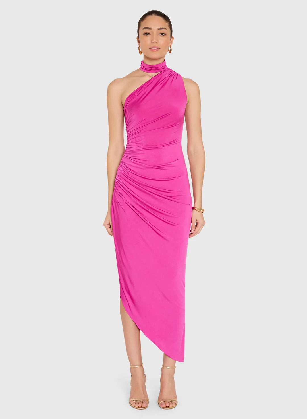 Woman wearing a bright pink one-shoulder dress on a white background