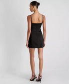 Woman wearing a black dress on a white background