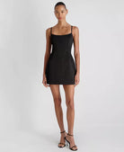 Woman wearing a black dress on a white background