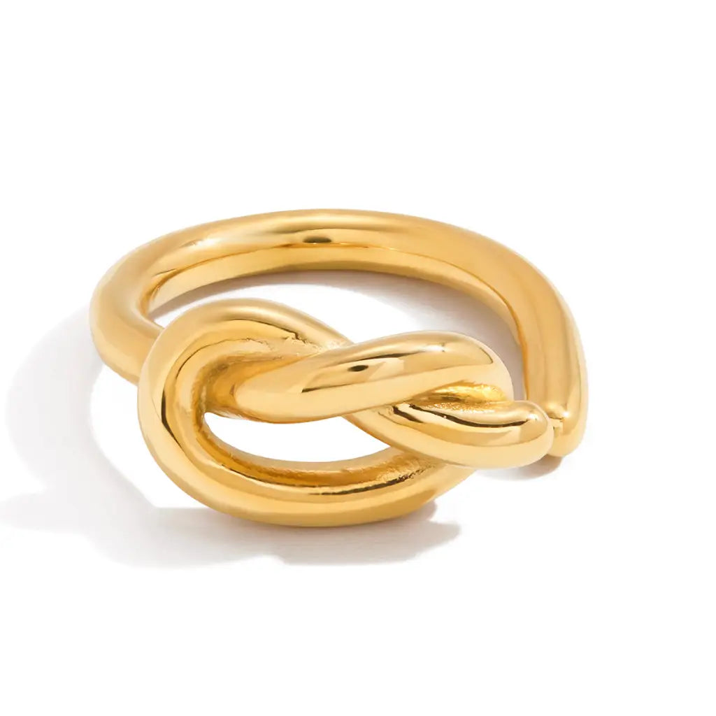 Gold knot ring on a white background