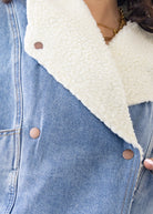Close-up of a denim jacket with a white sherpa lining