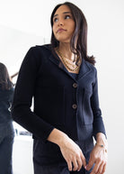 Woman wearing a dark blue blazer with a blurred background