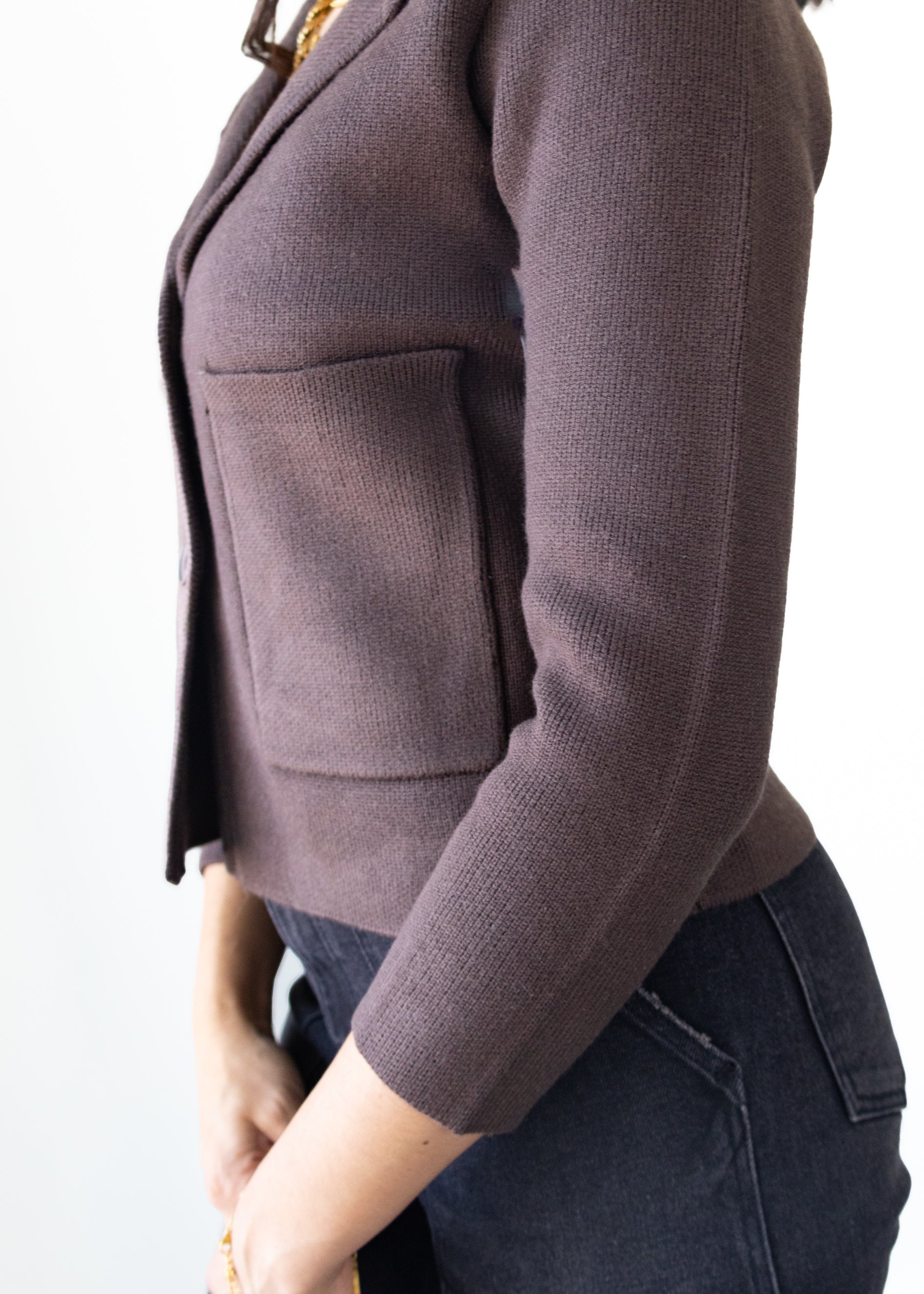 Brown blazer worn by a person on a white background