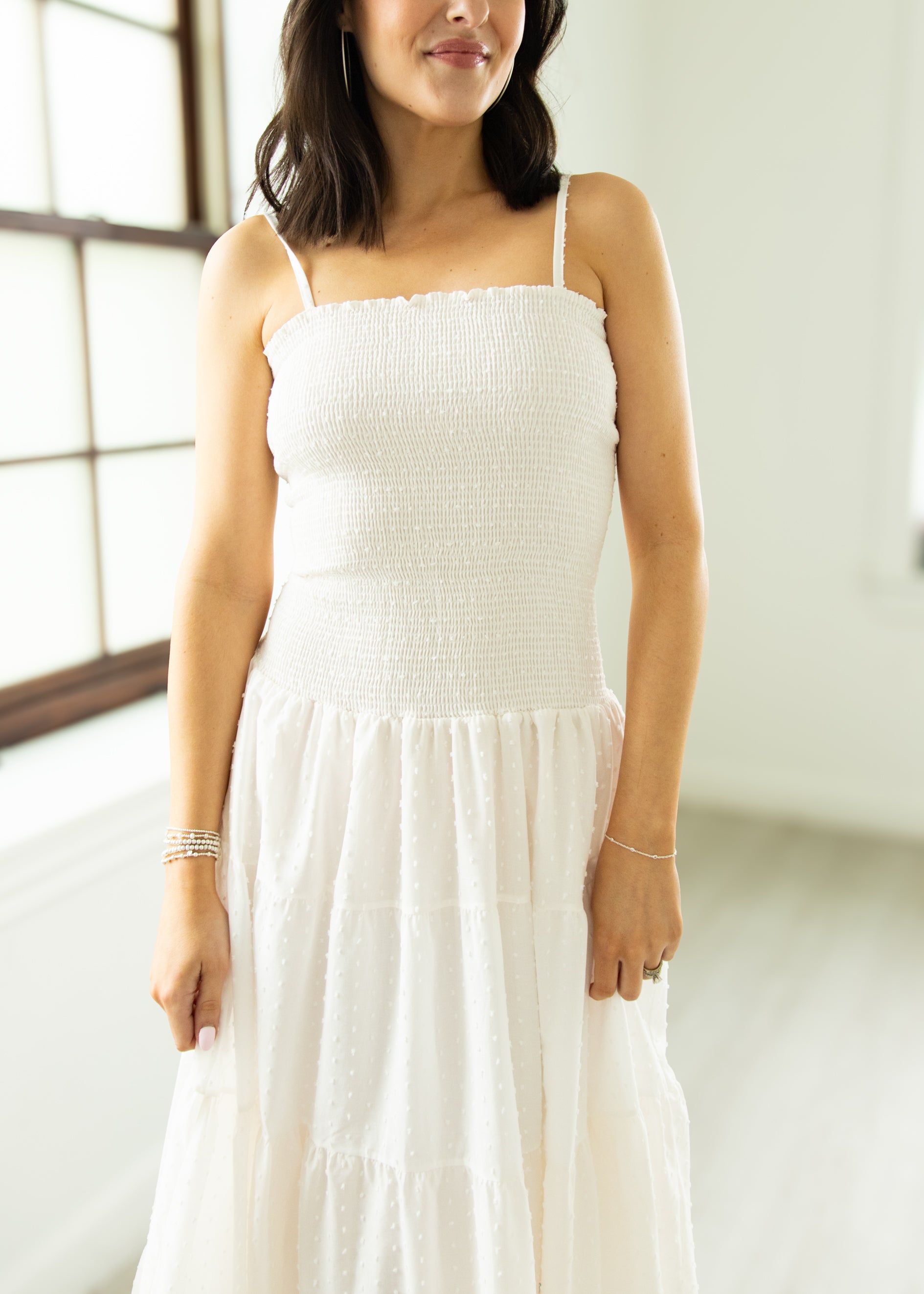 Woman wearing a white dress in a bright room