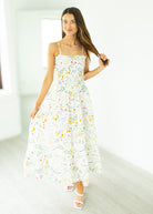Woman wearing a floral dress in a minimalistic setting