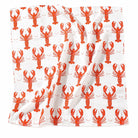 A square white bandana scarf featuring a repeating pattern of bright orange-red lobsters on a white background