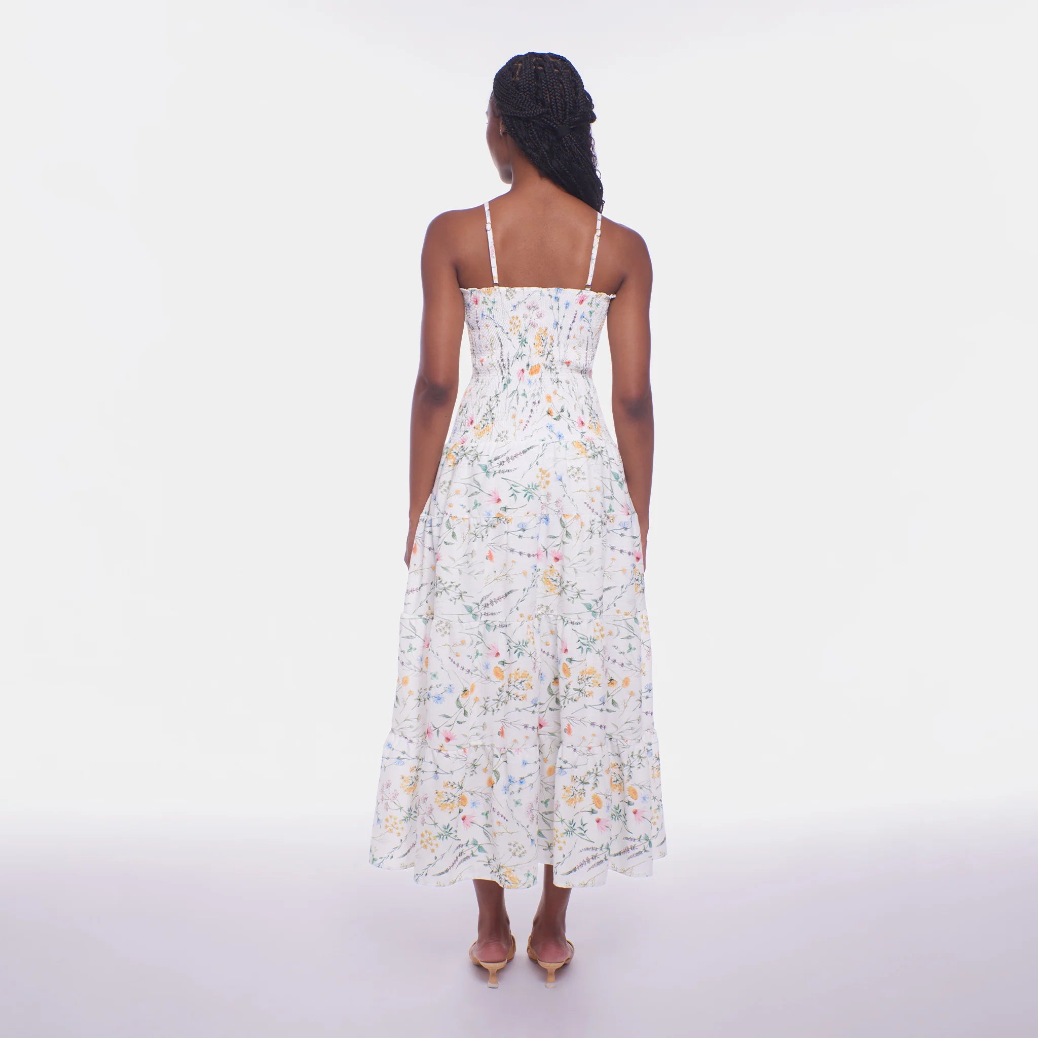 Woman wearing a floral dress on a white background
