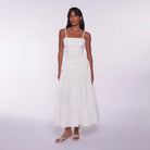 Woman wearing a white dress against a white background