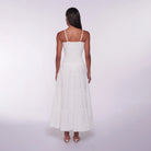 Woman wearing a white dress on a plain background