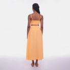 Woman wearing a yellow dress on a white background