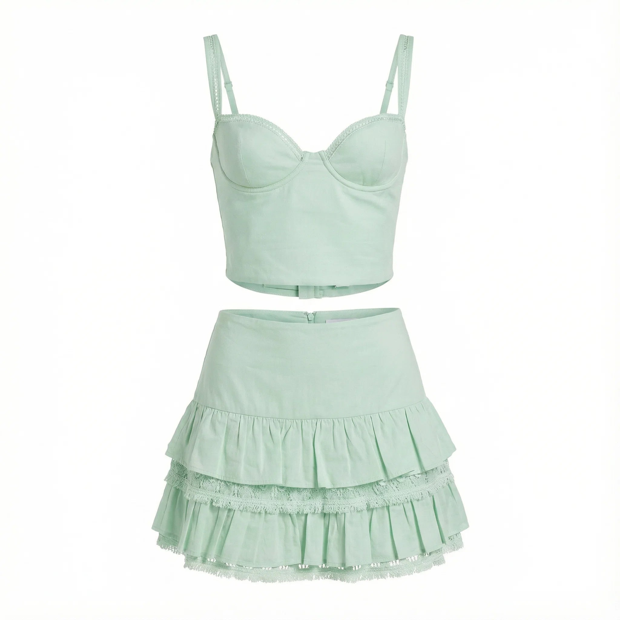 Light green two-piece set with a top and ruffled skirt on a white background