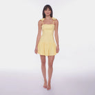Woman wearing a yellow dress on a white background