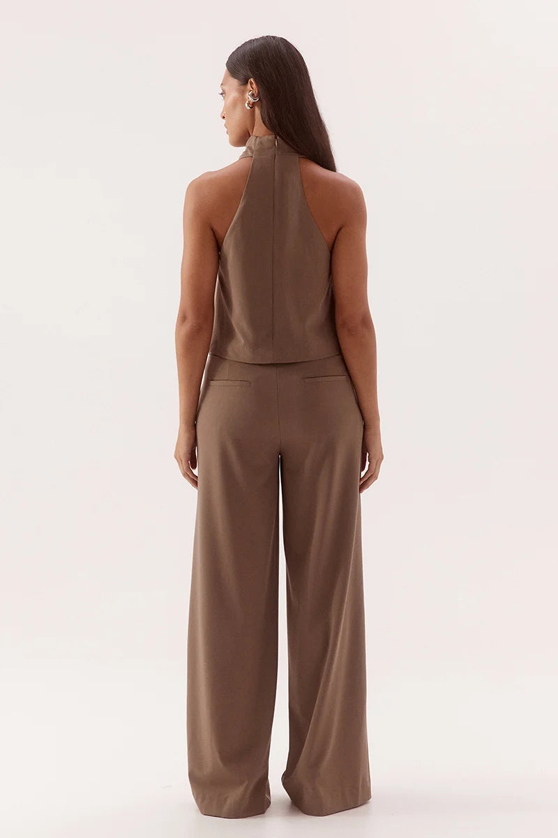 Woman wearing a brown set on a white background