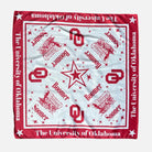 A square University of Oklahoma themed bandana or scarf laid flat on a light gray background. The design features a white center with red logos, stars, and text, surrounded by a red border with white stars and 'The University of Oklahoma' printed along the edges.