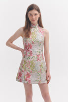 Woman wearing a floral dress on a white background