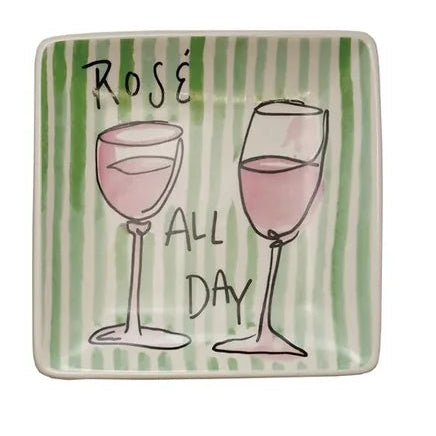 square ceramic plates with cocktail-themed designs and text on a white background