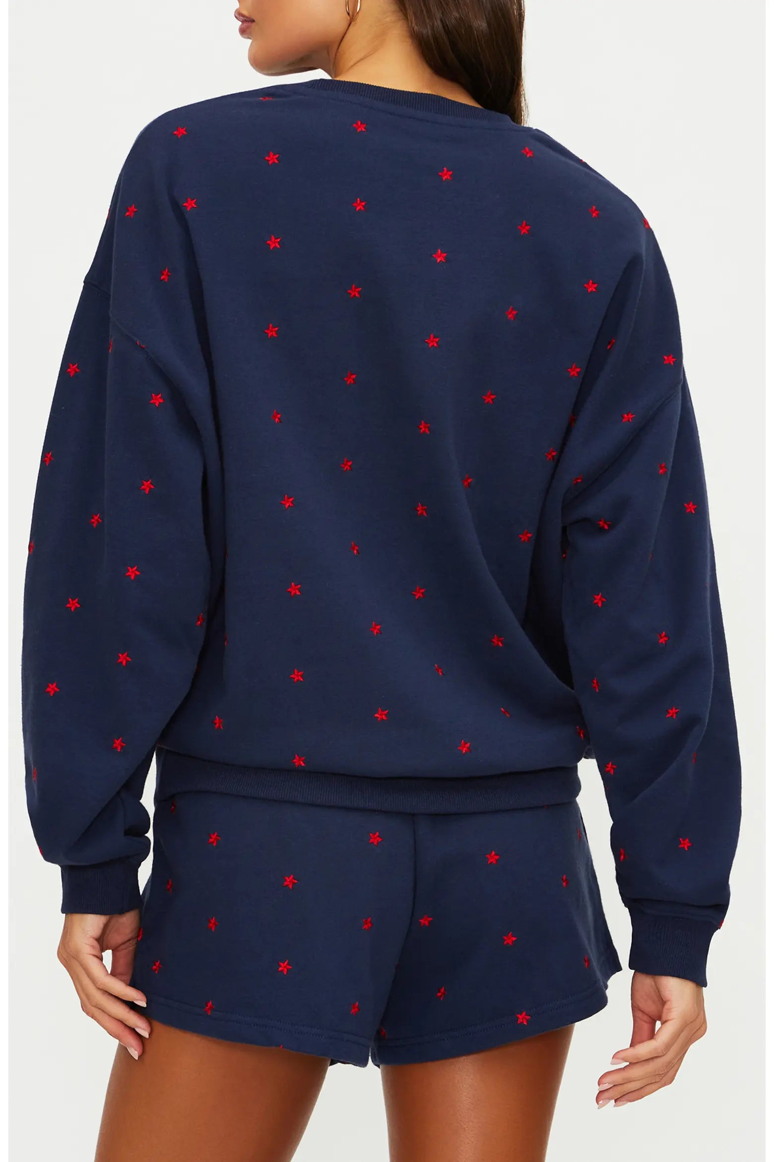 Navy sweatshirt and shorts set with red stars on a white background