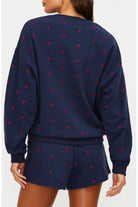 Navy sweatshirt and shorts set with red stars on a white background