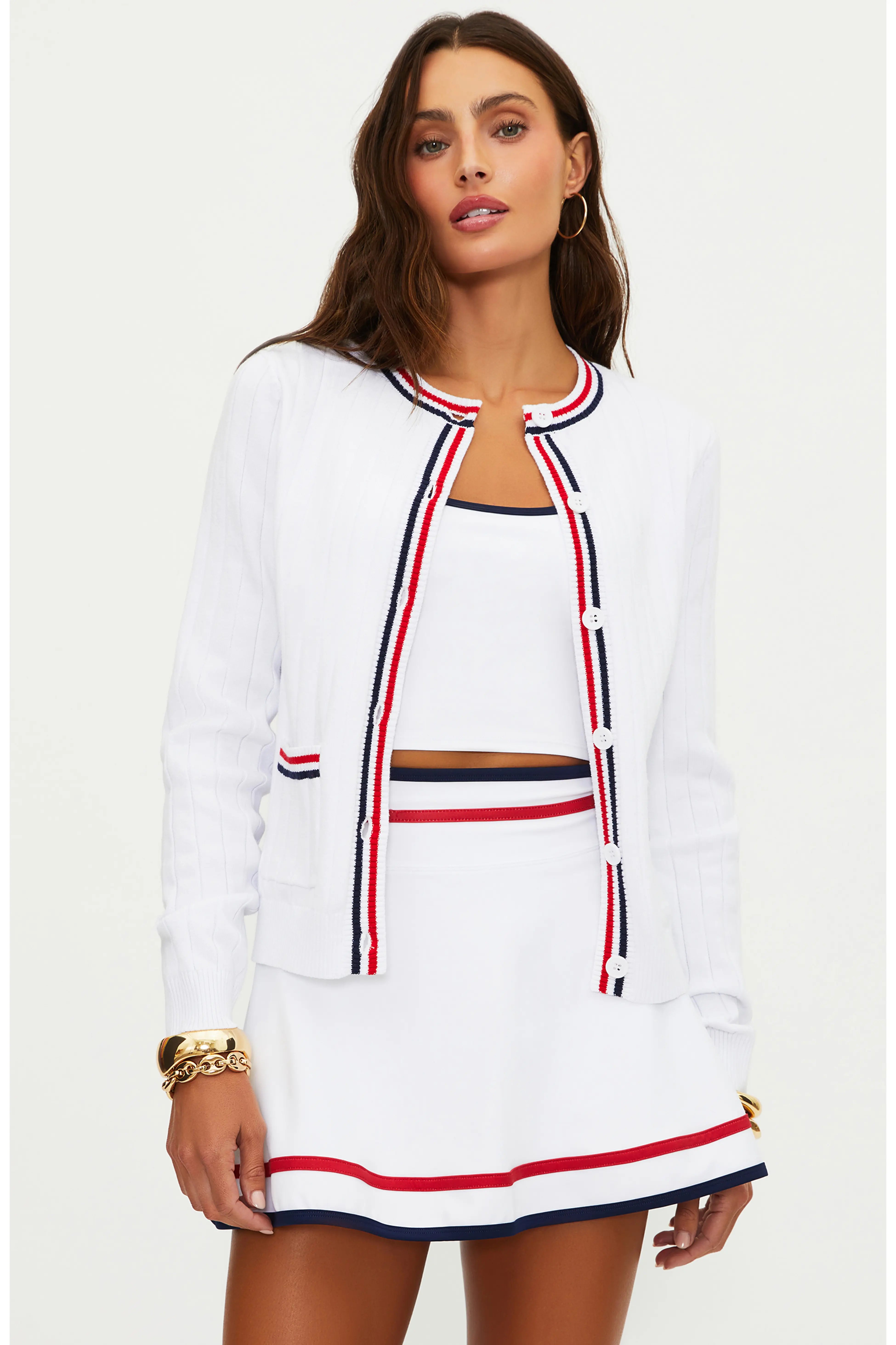 Woman wearing a white outfit with red and blue accents on a white background
