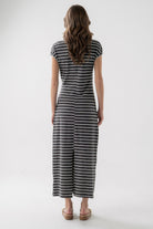 Woman wearing a black and white striped dress on a white background
