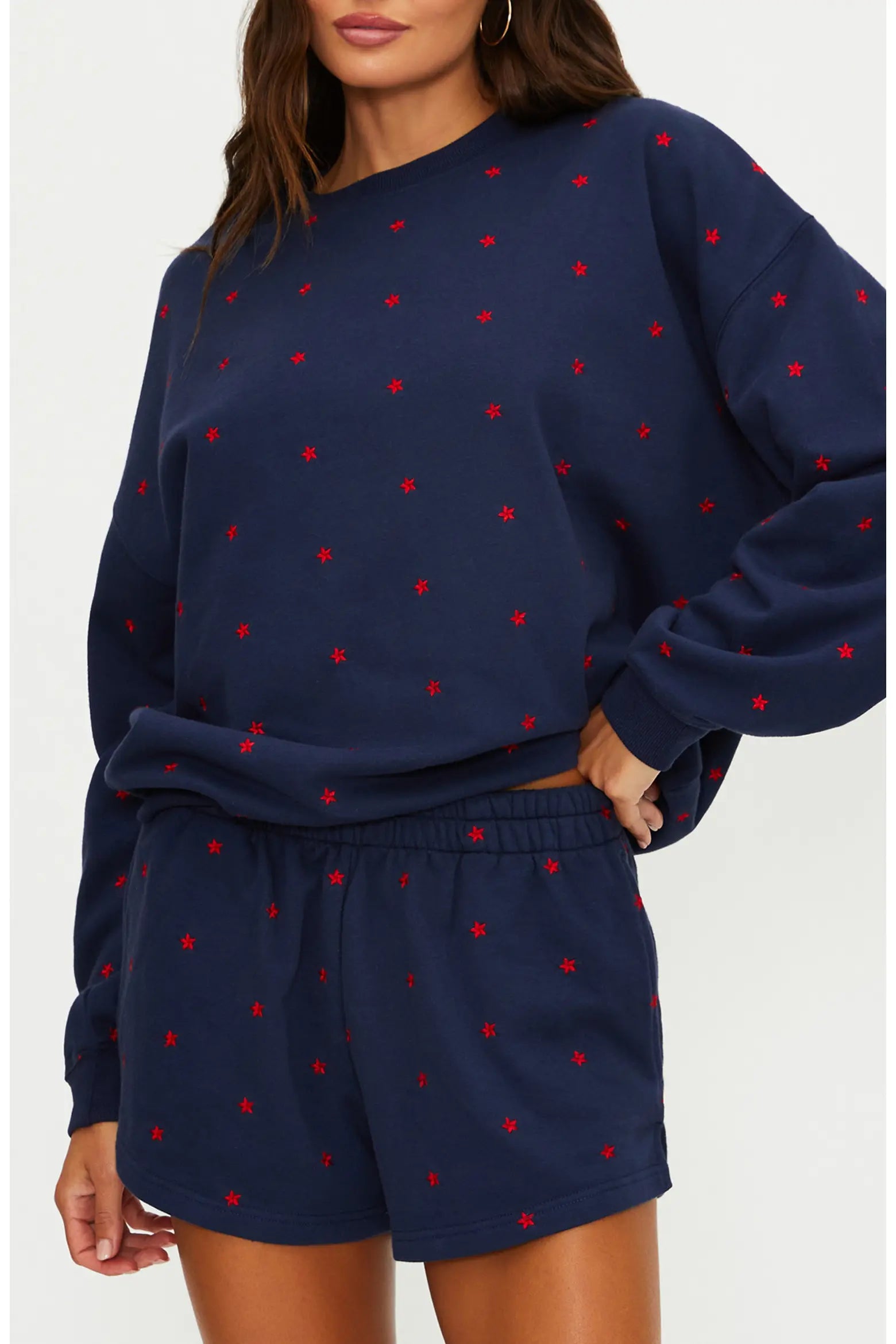 Navy sweatshirt and shorts set with red stars on a white background