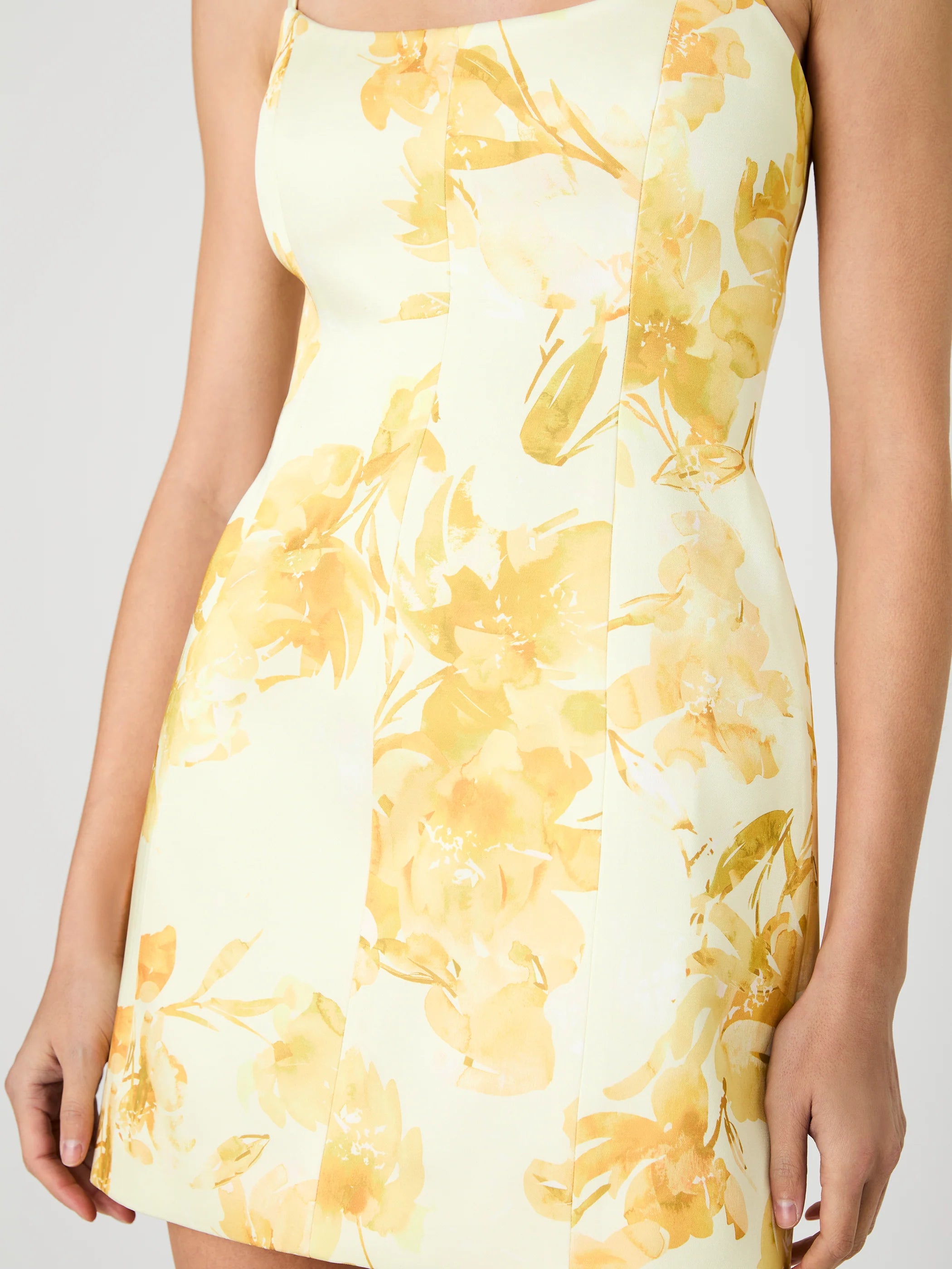 Yellow floral dress on a plain background