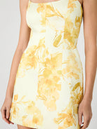 Yellow floral dress on a plain background