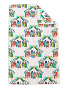 A kitchen tea towel with a colorful Christmas nativity print, featuring a folded corner showing the reverse side with a red and green Christmas design.