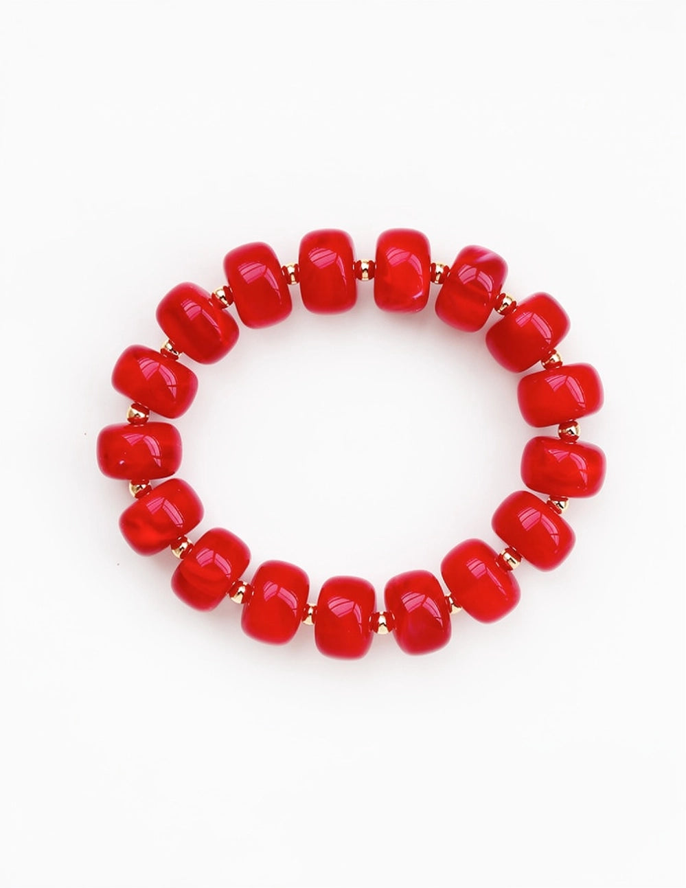 A beaded stretch bracelet made of glossy, rounded red beads separated by small gold spacer beads, shown on a plain white background.