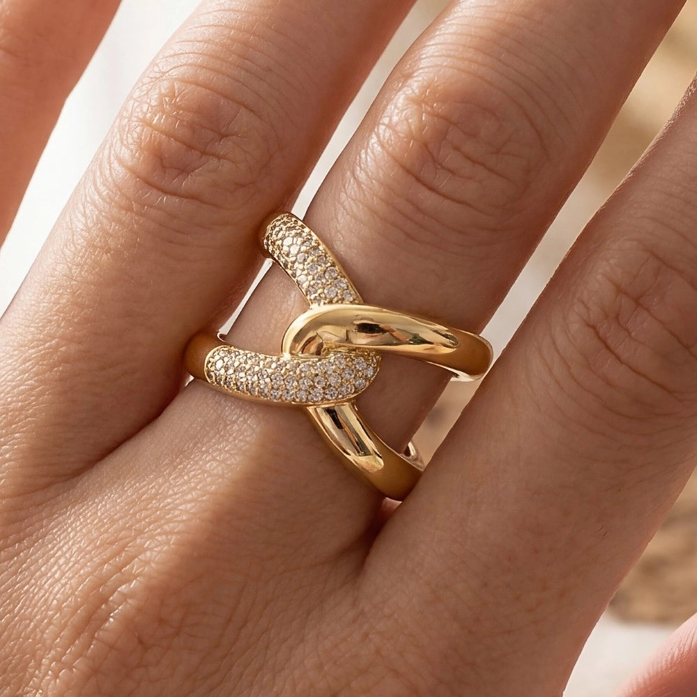 Gold ring with diamond accents on a person's finger