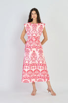 Woman wearing a red and white patterned dress on a white background
