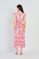 Woman wearing a red and white patterned dress on a white background