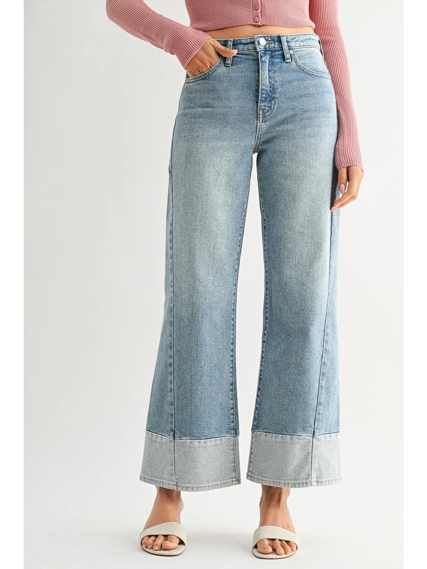 Light blue flared jeans worn by a person on a white background