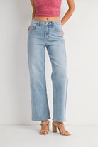 Light blue jeans worn by a person on a white background