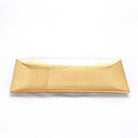 A rectangular gold ceramic plate with a textured, metallic finish, photographed from a top-down perspective on a clean white background.